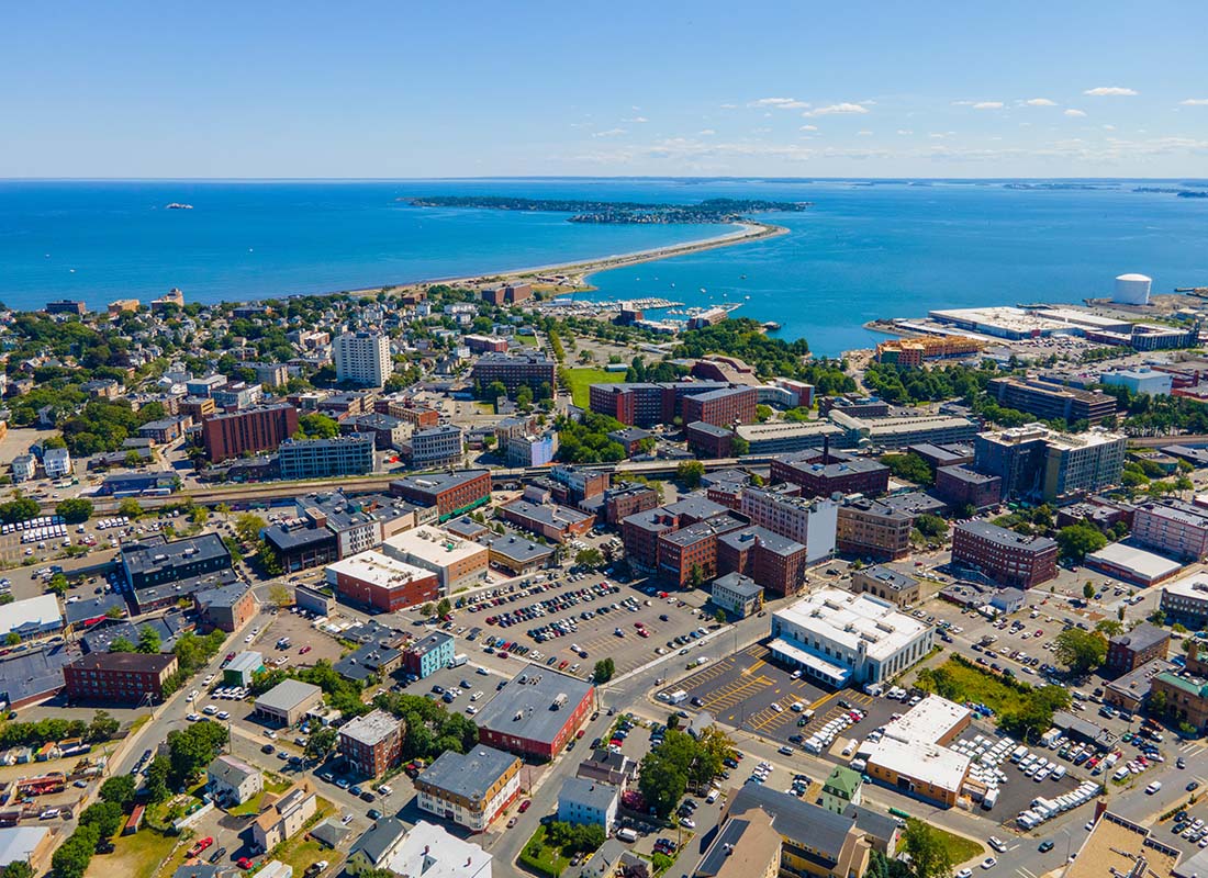 We Are Independent - Aerial View of Buildings in Downtown Lynn Massachusetts Next to the Ocean on a Sunny Day